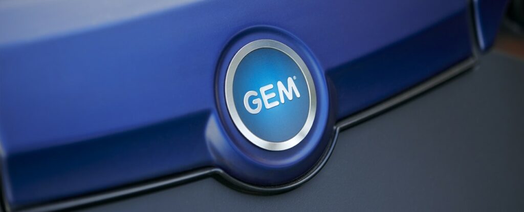 Close up of GEM logo hood of a blue electric vehicle