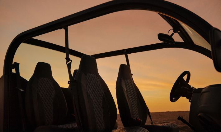 Close up of interior of electric vehicle in the sand at sunset