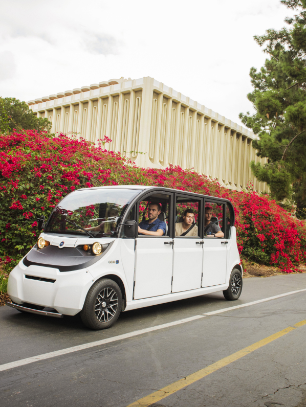 People riding in an electric shuttle vehicle