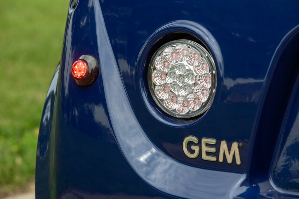 Close up of electric vehicle GEM logo and headlight