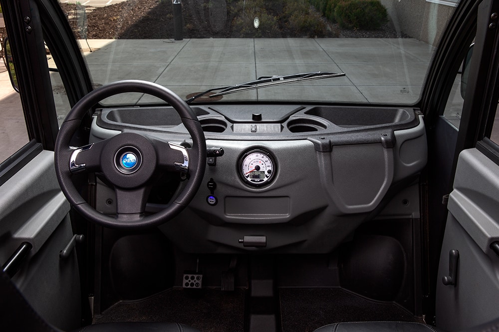 Close up of GEM steering wheel and dashboard inside an electric vehicle