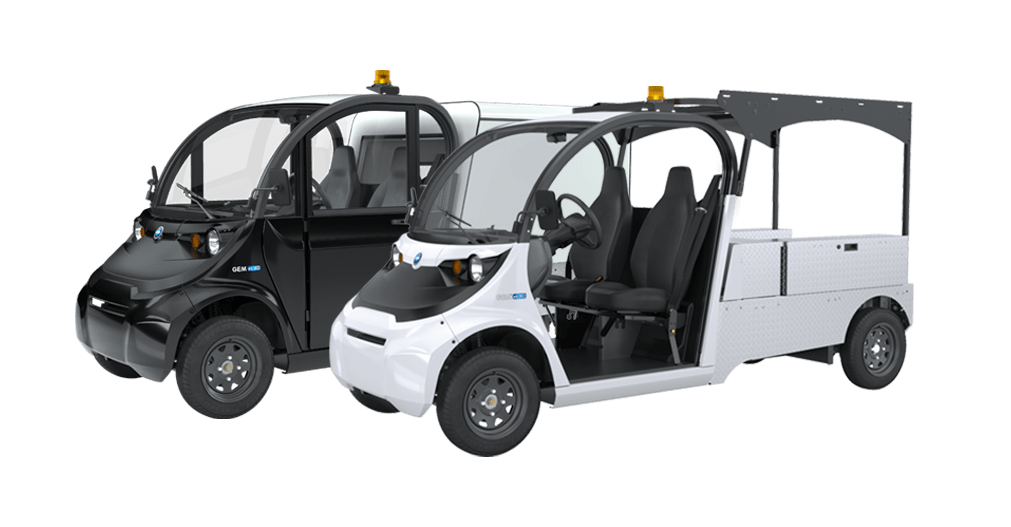 Two side by side electric vehicles : one with an open cab option and the other a closed cab option