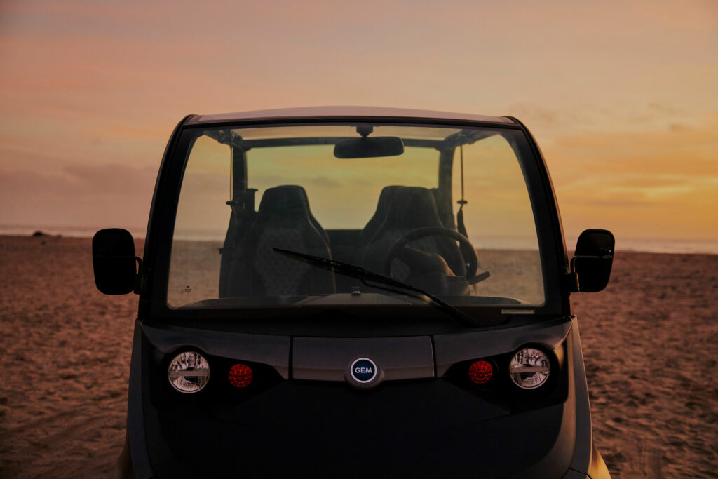 Close up of an electric vehicle on the beach at sunset