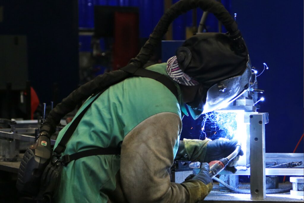 Waev team member welding an electric vehicle in Anaheim, California manufacturing facility
